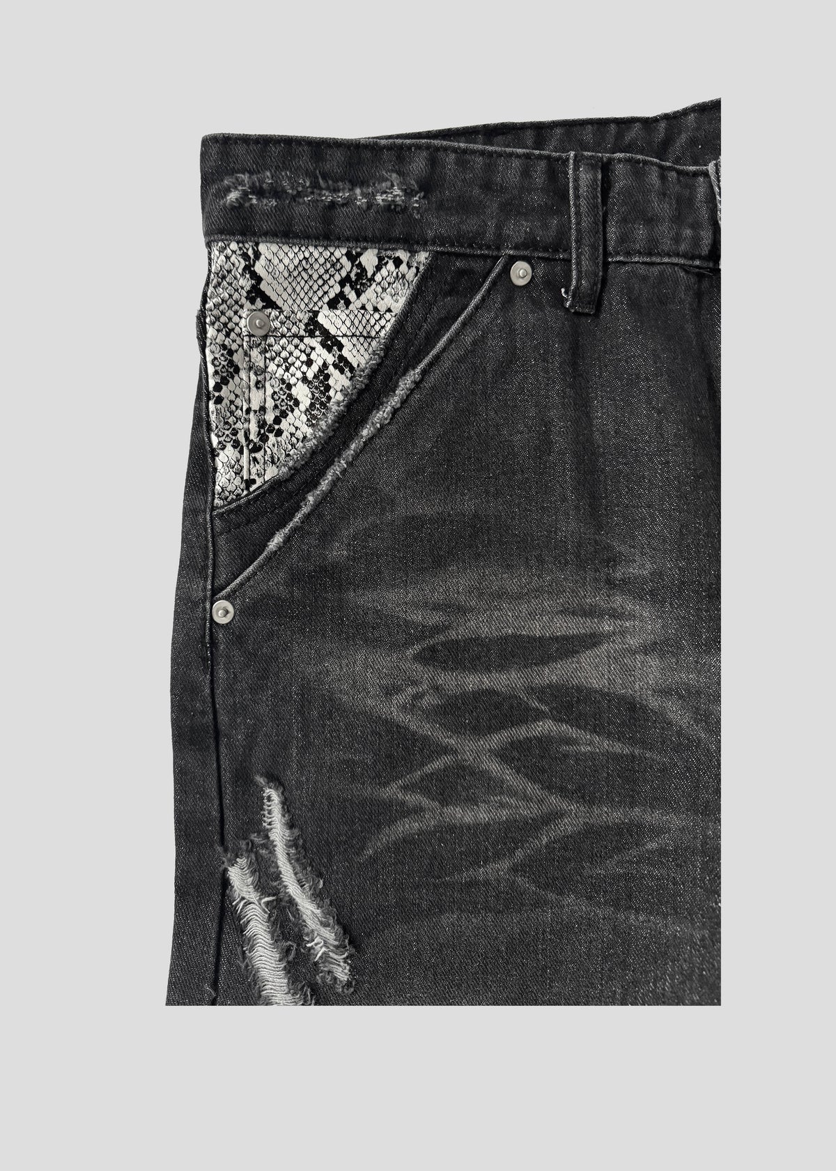 Close-up of the ONEFATE Snake Jeans front pocket with snake-pattern panel, belt loop and button