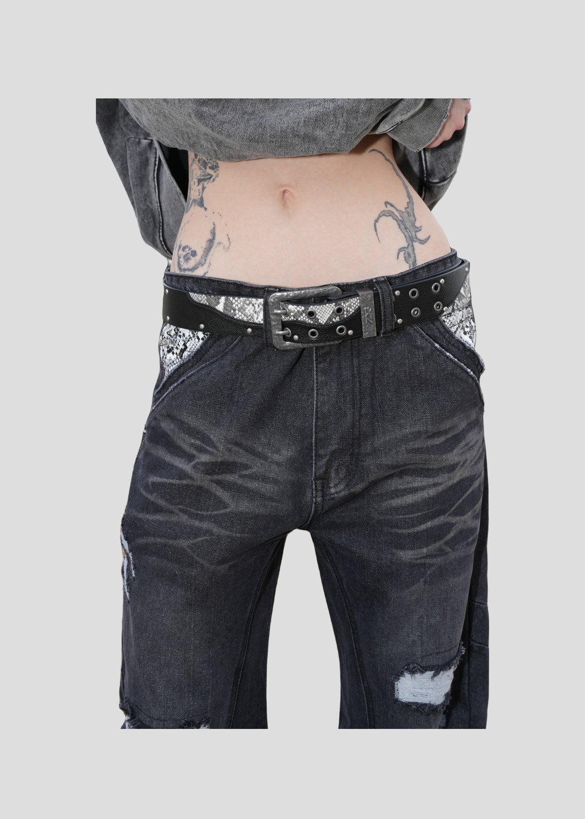 Model wearing the ONEFATE Snake Belt with black Snake Jeans, front view at the waist